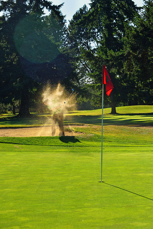 MIchelle chipping out of bunker 2nd hole